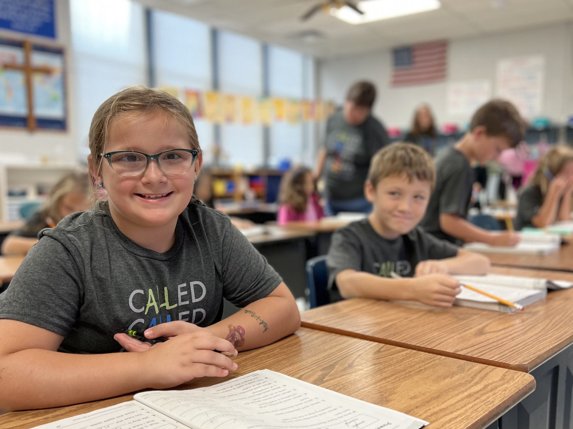 Teacher helping students at St. James